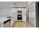 Close up of modern kitchen featuring stainless steel appliances and white cabinetry at 10773 Bede Ct, Las Vegas, NV 89166
