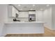 Open-concept kitchen featuring white cabinets, quartz countertops, and stainless steel appliances at 10773 Bede Ct, Las Vegas, NV 89166