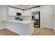 Open-concept kitchen featuring white cabinets, quartz countertops, and stainless steel appliances at 10773 Bede Ct, Las Vegas, NV 89166