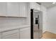 Modern kitchen featuring white cabinets, light countertops, and a stainless steel refrigerator at 10773 Bede Ct, Las Vegas, NV 89166