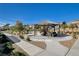 Community picnic pavilion with seating, walking path, lush landscaping, and views of surrounding townhomes at 10773 Bede Ct, Las Vegas, NV 89166