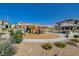 Community playground area featuring a playset, picnic pavilion, lush landscaping, and surrounding townhomes at 10773 Bede Ct, Las Vegas, NV 89166