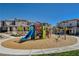 Community playground area featuring a playset with slides, climbing features, and lush landscaping at 10773 Bede Ct, Las Vegas, NV 89166