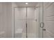 New shower with white subway tile, glass door, shower bench and chrome hardware at 10773 Bede Ct, Las Vegas, NV 89166