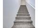 Carpeted staircase with white walls, providing access to the upper levels of the home at 10773 Bede Ct, Las Vegas, NV 89166