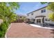 Home's backyard featuring a hot tub, covered patio area, and low-maintenance landscaping at 11134 Casala Ct, Las Vegas, NV 89141