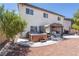 Backyard view of the home featuring a hot tub, covered patio, and low maintenance desert landscaping at 11134 Casala Ct, Las Vegas, NV 89141