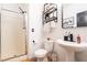 Bathroom featuring white cabinets, shower with glass door, and modern fixtures at 11134 Casala Ct, Las Vegas, NV 89141
