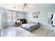 Relaxing bedroom with light blue walls, wood flooring, and natural light from the window at 11134 Casala Ct, Las Vegas, NV 89141