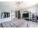 Spacious bedroom with light blue walls, wood flooring, ceiling fan, and closet at 11134 Casala Ct, Las Vegas, NV 89141