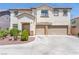 Inviting two-story home featuring a spacious three-car garage and well-manicured front yard at 11134 Casala Ct, Las Vegas, NV 89141