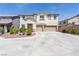Inviting two-story home featuring a spacious three-car garage and well-manicured front yard at 11134 Casala Ct, Las Vegas, NV 89141