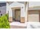 Close up of front entrance and tan colored front door of this two-story home at 11134 Casala Ct, Las Vegas, NV 89141