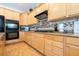 Kitchen featuring wood cabinets, stainless oven and microwave, and tile backsplash at 11134 Casala Ct, Las Vegas, NV 89141