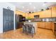Spacious kitchen with wood cabinets, stainless appliances, center island and three chairs at 11134 Casala Ct, Las Vegas, NV 89141