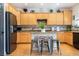 Open kitchen with wooden cabinets, stainless steel appliances, island and hardwood floors at 11134 Casala Ct, Las Vegas, NV 89141