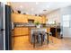Bright kitchen with wood cabinets, stainless appliances, center island and three chairs at 11134 Casala Ct, Las Vegas, NV 89141