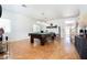 Spacious living room featuring beautiful hardwood floors and a stylish pool table at 11134 Casala Ct, Las Vegas, NV 89141