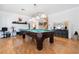 Spacious living room featuring beautiful hardwood floors and a stylish pool table at 11134 Casala Ct, Las Vegas, NV 89141
