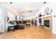 Open living room featuring a fireplace, wood floors, windows, and comfortable furniture at 11134 Casala Ct, Las Vegas, NV 89141