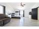 A bright main bedroom featuring a ceiling fan, lots of natural light, and gray wood floors at 11134 Casala Ct, Las Vegas, NV 89141