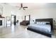 Spacious main bedroom featuring a ceiling fan, fireplace, and light gray wood floors at 11134 Casala Ct, Las Vegas, NV 89141