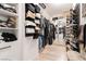Large walk-in closet with installed rack systems, mirror, and gray wood floors at 11134 Casala Ct, Las Vegas, NV 89141