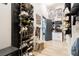 Walk-in closet with installed rack systems, bench, and gray wood floors at 11134 Casala Ct, Las Vegas, NV 89141