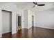 Spacious bedroom with hardwood floors, ceiling fan, and multiple closets at 11157 Sandy Grove Ave, Las Vegas, NV 89144