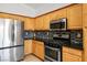 Updated kitchen features stainless steel appliances, granite countertops and wood cabinets at 11157 Sandy Grove Ave, Las Vegas, NV 89144