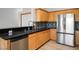 Updated kitchen features stainless steel appliances, granite countertops and wood cabinets at 11157 Sandy Grove Ave, Las Vegas, NV 89144