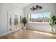 Bright living space featuring double doors and a large window with backyard views at 11157 Sandy Grove Ave, Las Vegas, NV 89144
