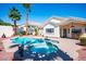 Resort-style pool with palm trees, hot tub, and landscaped backyard at 11157 Sandy Grove Ave, Las Vegas, NV 89144