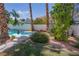 Sparkling pool and spa surrounded by lush landscaping create a backyard oasis at 185 Camrose St, Henderson, NV 89074