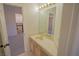 Bathroom featuring a vanity with storage, a large mirror, and a doorway to another room at 185 Camrose St, Henderson, NV 89074