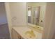 Clean bathroom with a sink, white tile, and a view into another room at 185 Camrose St, Henderson, NV 89074