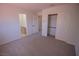 Cozy bedroom with neutral carpeting, closet, and access to an en-suite bathroom at 185 Camrose St, Henderson, NV 89074