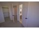 Bedroom featuring doorways to the bathroom and closet, with neutral colored carpet at 185 Camrose St, Henderson, NV 89074