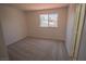 Bright bedroom with a window providing natural light and neutral-colored carpet at 185 Camrose St, Henderson, NV 89074