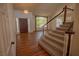 Welcoming foyer with hardwood floors, a decorative front door, and a staircase at 185 Camrose St, Henderson, NV 89074