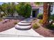 A beautiful front entrance welcomes you with custom stairs and desert landscaping at 185 Camrose St, Henderson, NV 89074