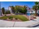 Beautiful two-story home boasts a landscaped front yard with palm trees and lush greenery at 185 Camrose St, Henderson, NV 89074