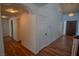 Bright hallway featuring hardwood floors, white walls, and a decorative wood door at 185 Camrose St, Henderson, NV 89074