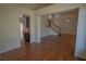 Open-concept living room with hardwood floors, staircase and natural light at 185 Camrose St, Henderson, NV 89074