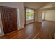 Inviting living room boasts hardwood floors and abundant natural light from a large arched window at 185 Camrose St, Henderson, NV 89074