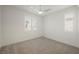Bright bedroom with carpet, ceiling fan, and shuttered windows providing natural light and a serene view at 19 Desert Ivy Ln, Henderson, NV 89011