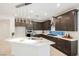 Stylish kitchen with stainless steel appliances, dark cabinetry, and a well-lit countertop at 19 Desert Ivy Ln, Henderson, NV 89011