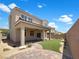 Beautiful backyard featuring desert landscaping, a covered patio, and a well-manicured lawn at 2125 Stone Well Rd, North Las Vegas, NV 89031