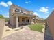 View of a spacious backyard that includes a covered patio, brick pavers, and artificial turf at 2125 Stone Well Rd, North Las Vegas, NV 89031