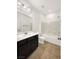 Bathroom featuring a shower-over-tub, a white countertop sink, and dark wood cabinets at 2125 Stone Well Rd, North Las Vegas, NV 89031